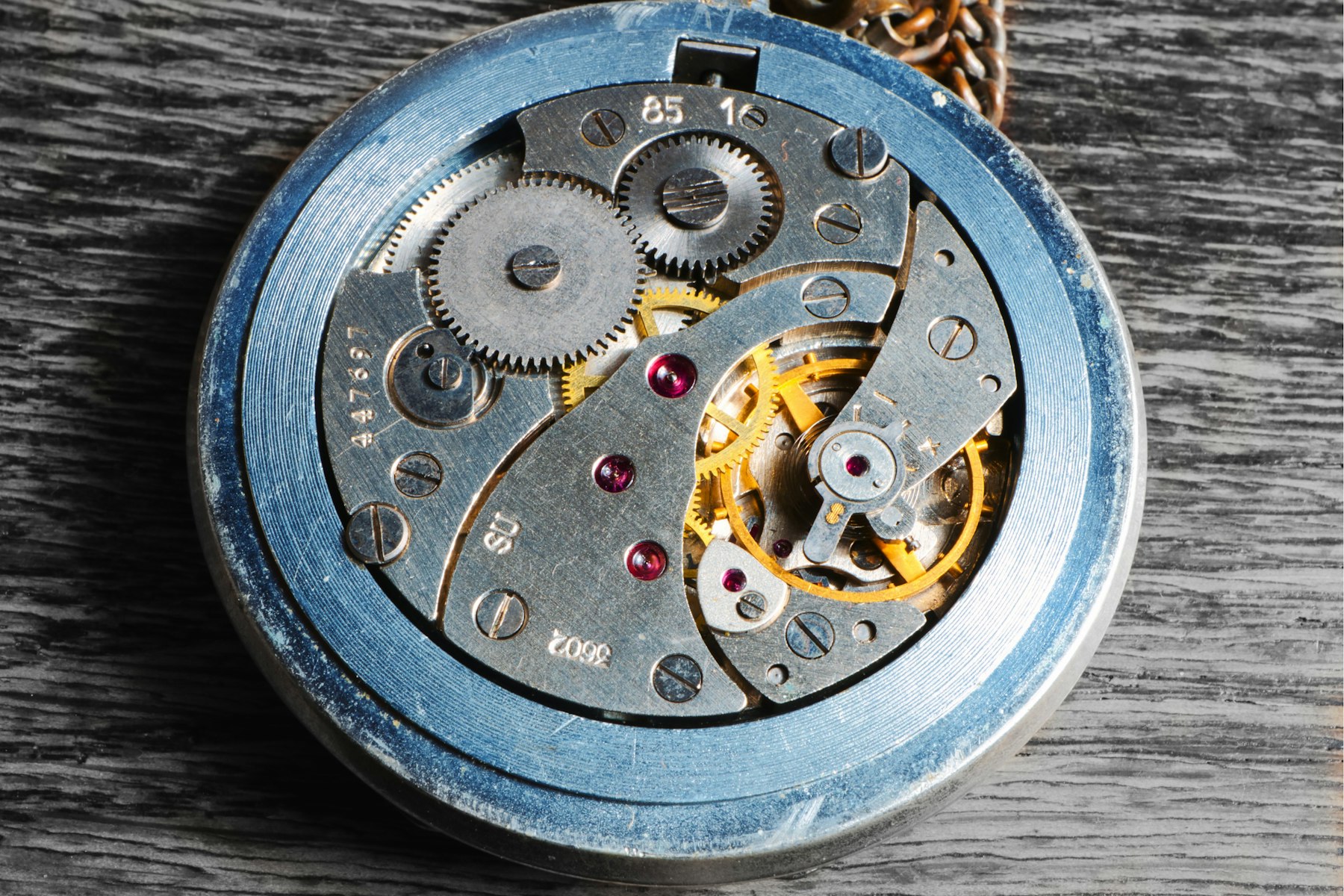Close view of an exposed mechanical watch movement with gears and jewels